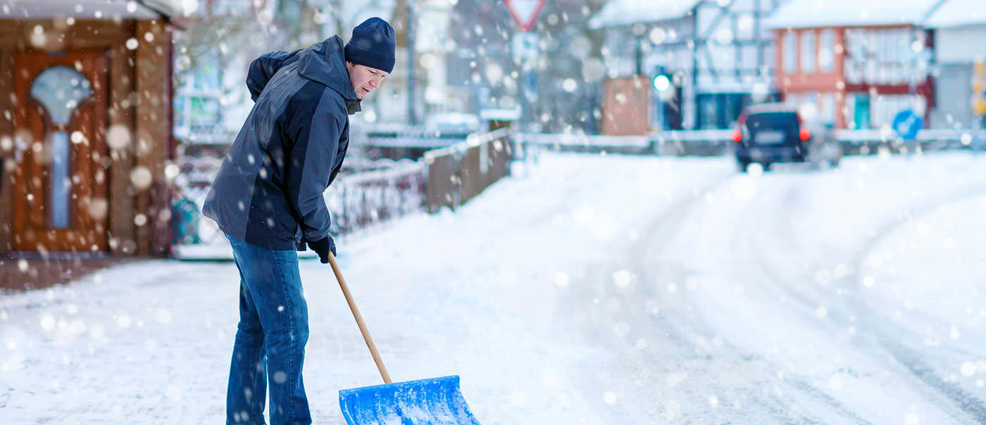 Man shoveling snow along sidewalk