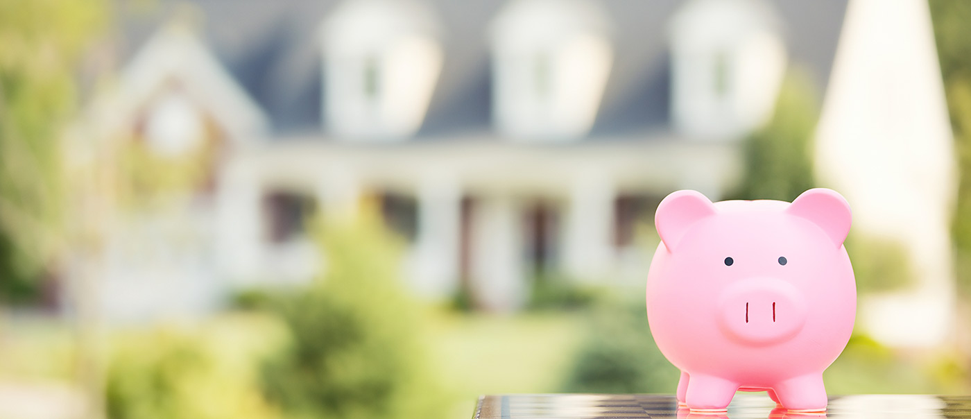 piggy bank in front of house
