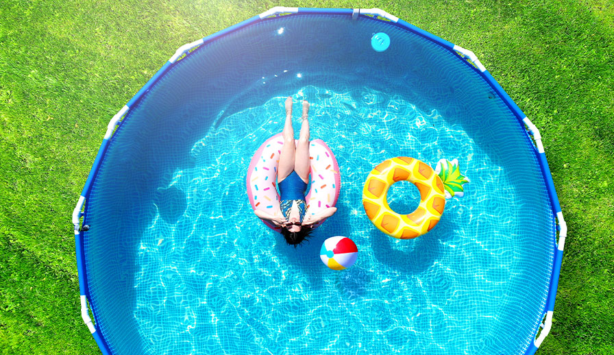 Woman floating on inflatable tube in swimming pool.