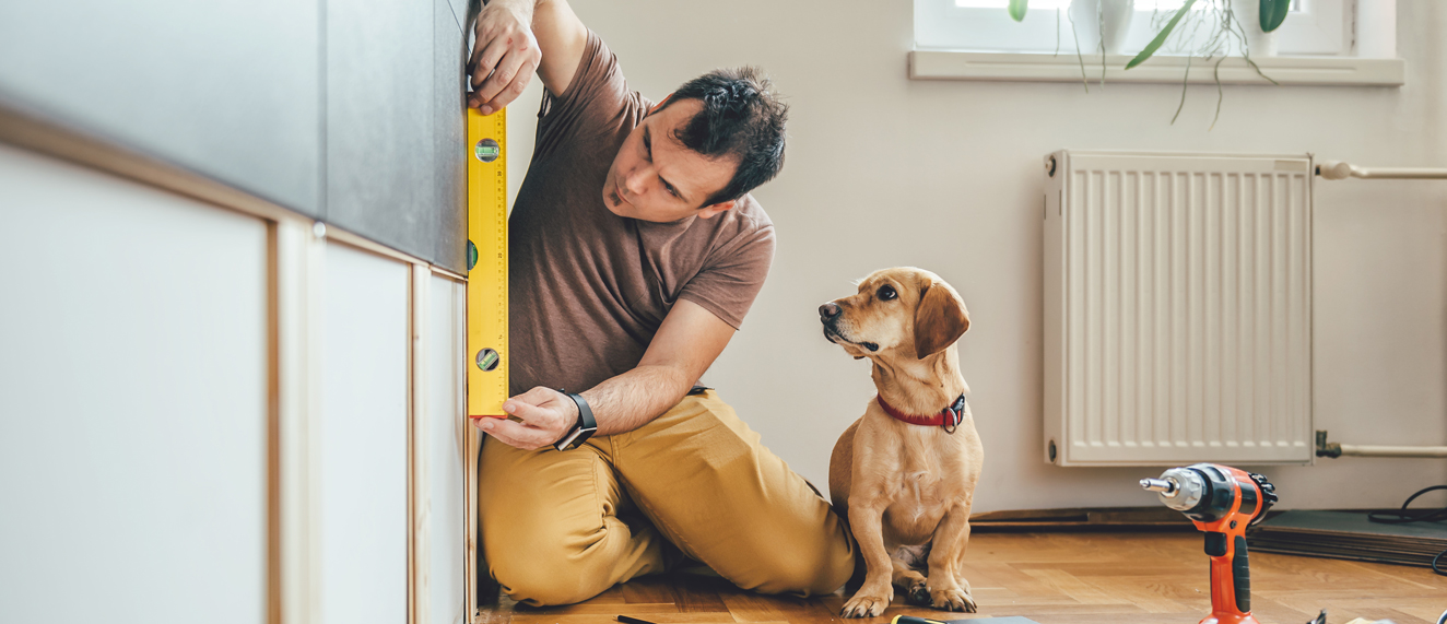 Man fixing things with his dog