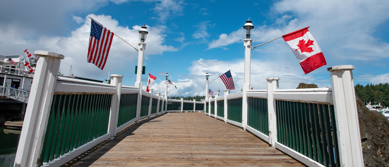 Canada-U.S. border with flags.