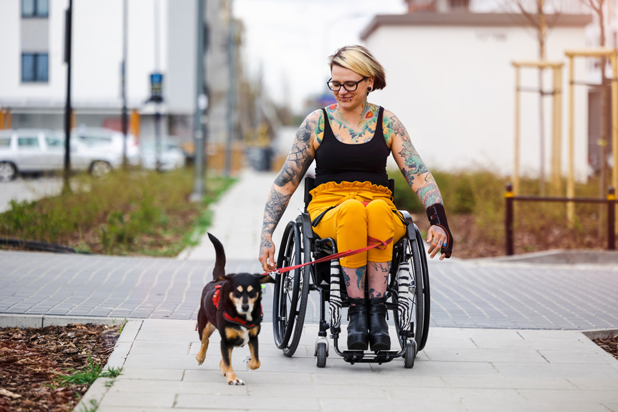 Woman in wheelchair with dog. 